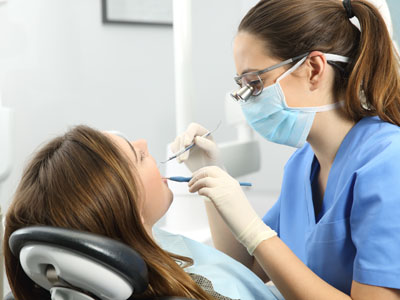 Dentist examining a patient teeth, Kary Dental