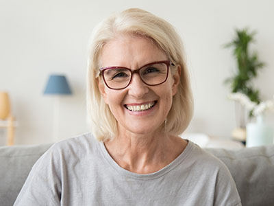 Smiling middle aged mature grey haired woman looking at camera, Kary Dental