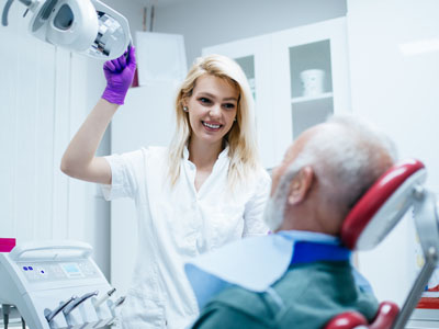 Senior man having dental treatment at dentists office, Kary Dental