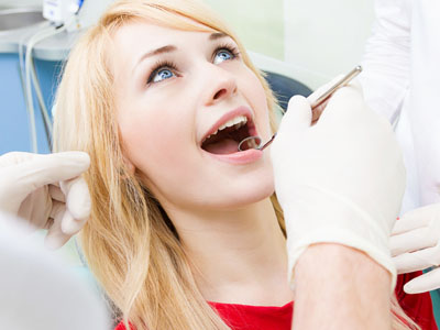 Female patient in dentist office getting oral exam procedure do, Kary Dental