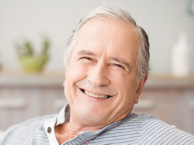 Portrait of senior man smiling at home, Kary Dental