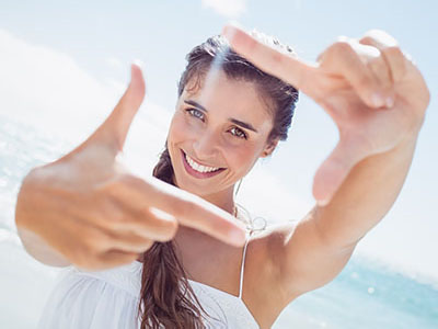 Portrait of smiling woman on the beach, Kary Dental